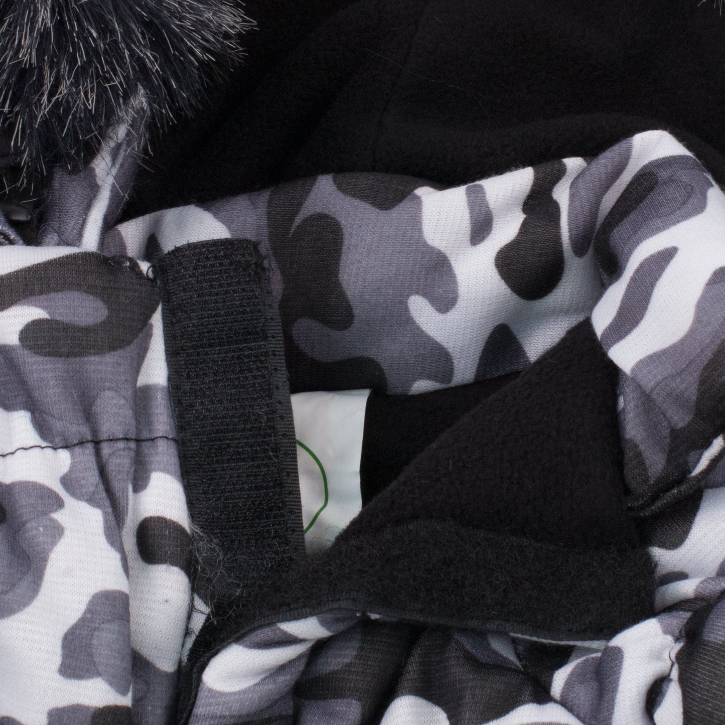 Close-up of 3M insulated dog parka with hood showcasing camouflage fabric and removable faux fur hood.