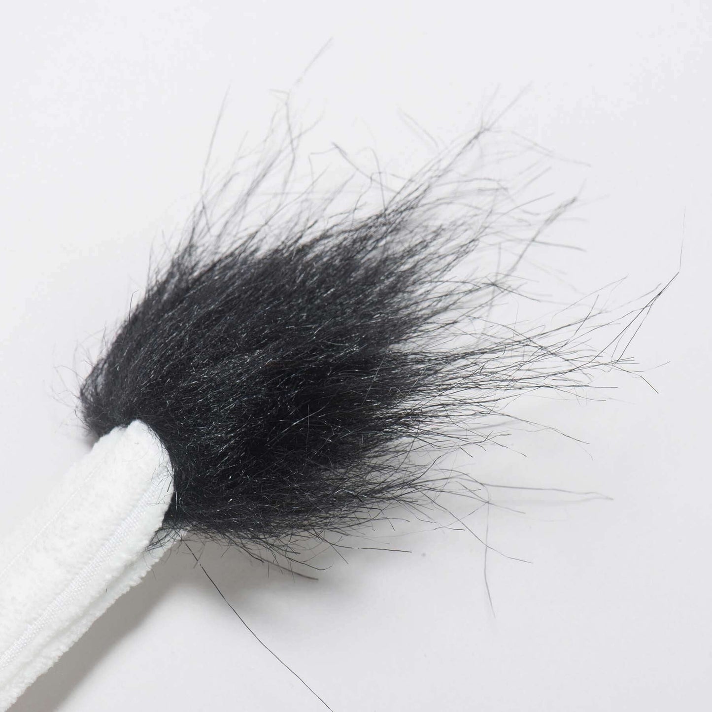 Dottie Cow Knottie Plush Dog Toy close-up showing the black furry tail detail for dogs and puppies.