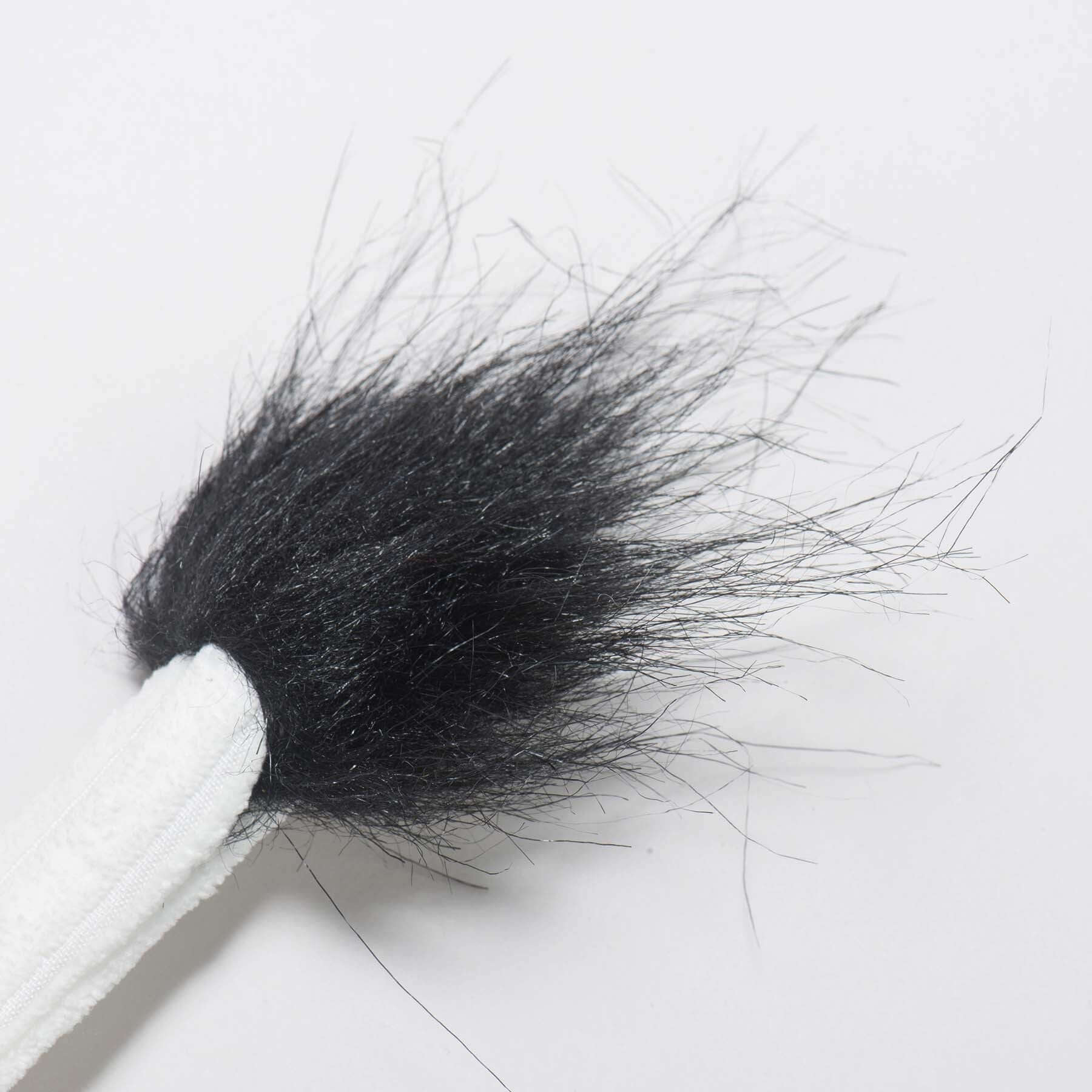 Dottie Cow Knottie Plush Dog Toy close-up showing the black furry tail detail for dogs and puppies.