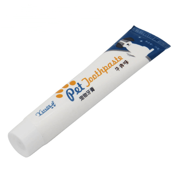 Dog Toothpaste by Dog Hugs Cat in a white tube with a blue label featuring a cartoon dog.