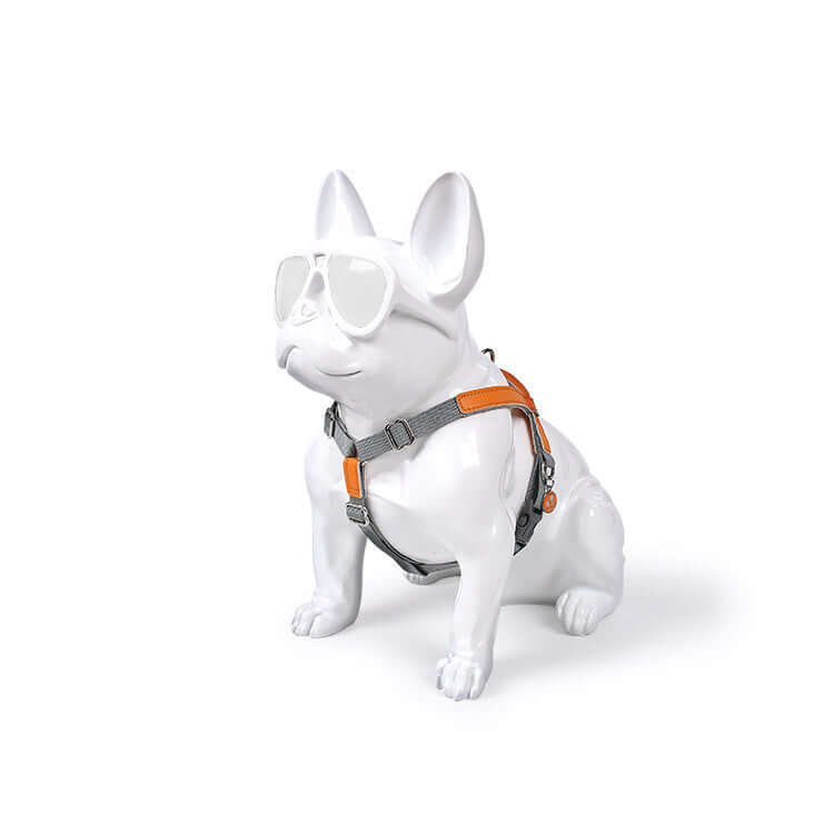 White dog statue wearing sunglasses and a Leather Dog Harness Leash Set in gray and orange color scheme.