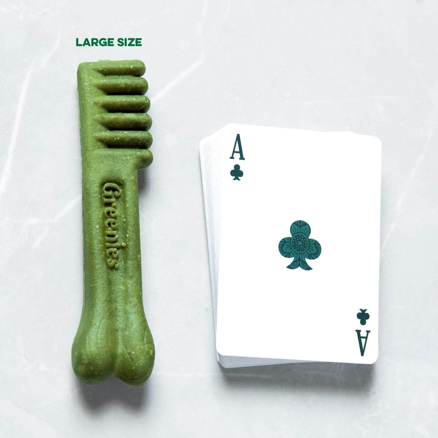 GREENIES Original Large Dental Treats next to an Ace playing card to show size comparison.