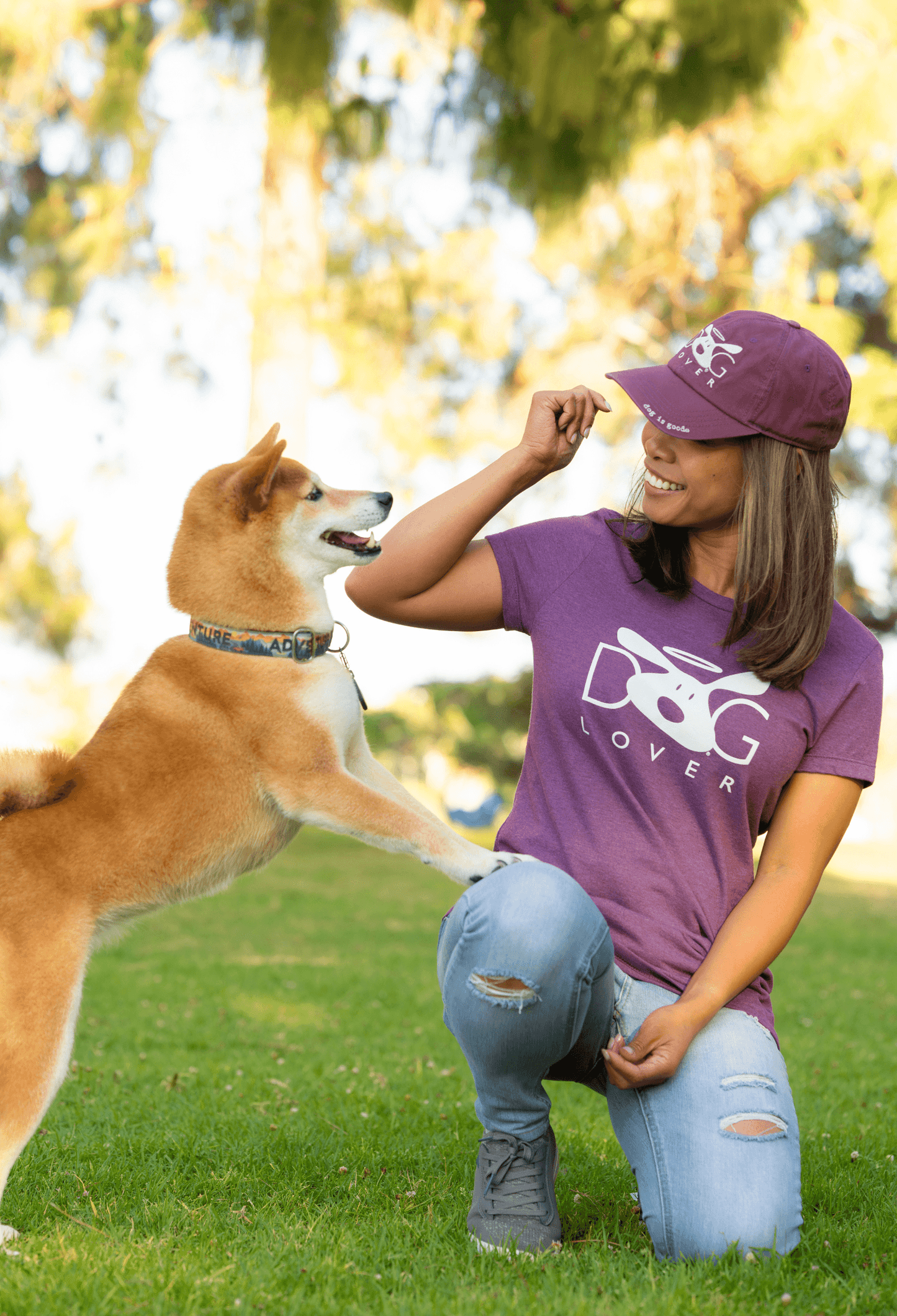 Dog Lover Plum-Short-Sleeved t-shirt with a dog in a park, showcasing love for dogs and style.