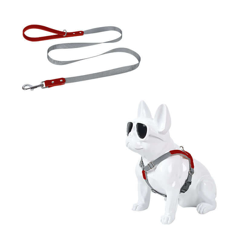 Leather Dog Harness Leash Set displayed on a decorative dog statue wearing sunglasses with a red and gray leash.