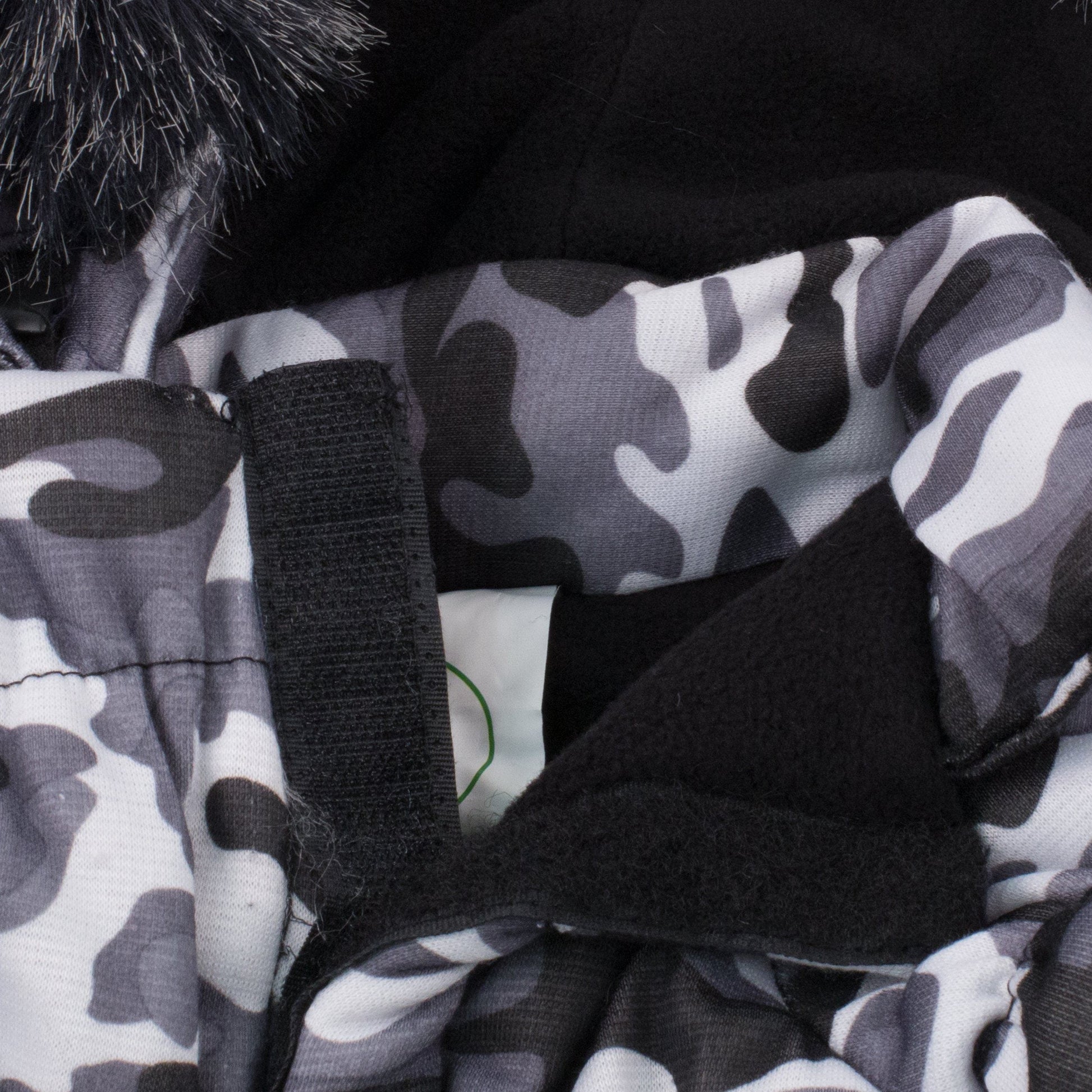 Close-up of 3M insulated dog parka with hood showcasing camouflage fabric and removable faux fur hood.